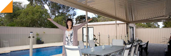 lady standing under a verandah by a pool