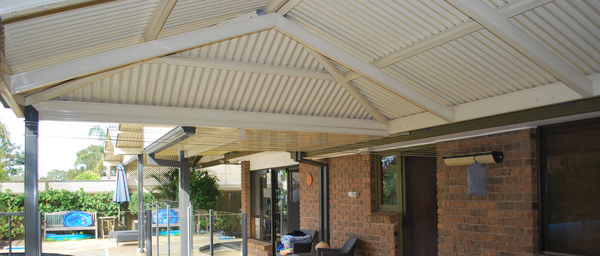 hip roof outdoor living area next to pool